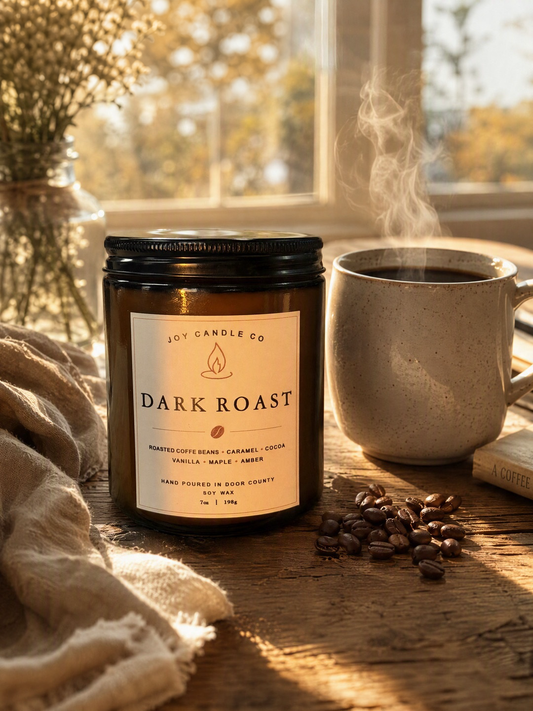Dark Roast soy candle beside a steaming mug of coffee on a sunlit wooden table