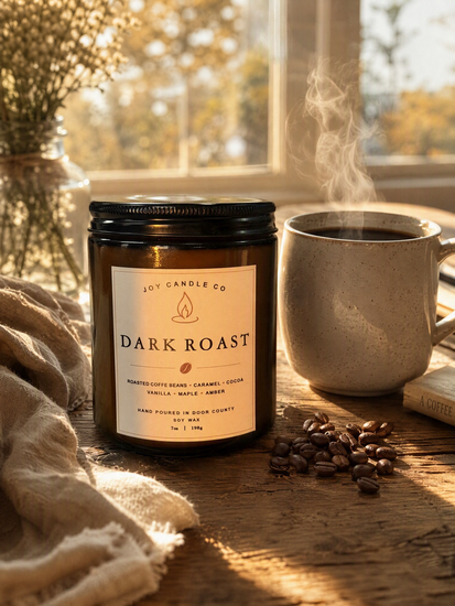 Dark Roast soy candle beside a steaming mug of coffee on a sunlit wooden table